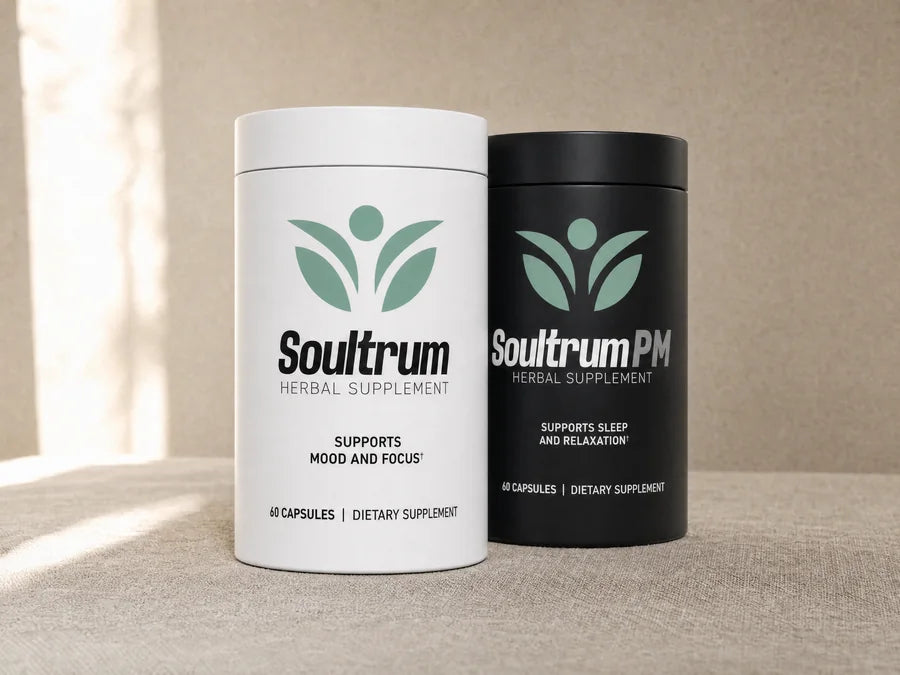 Soultrum daily supplement in a matte white canister standing in front of Soultrum PM in a matte black canister on a linen surface, with soft window light on a warm beige wall